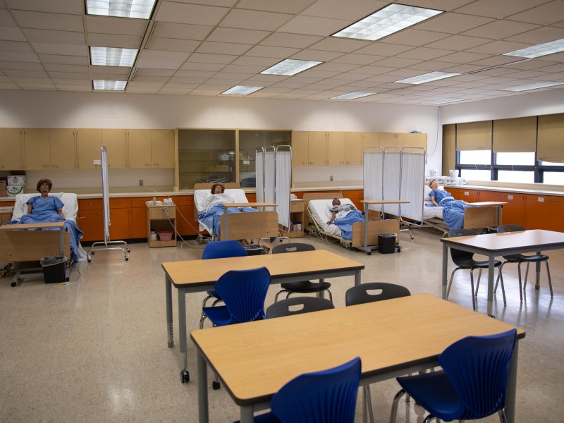 Classroom with desks and dummies in beds