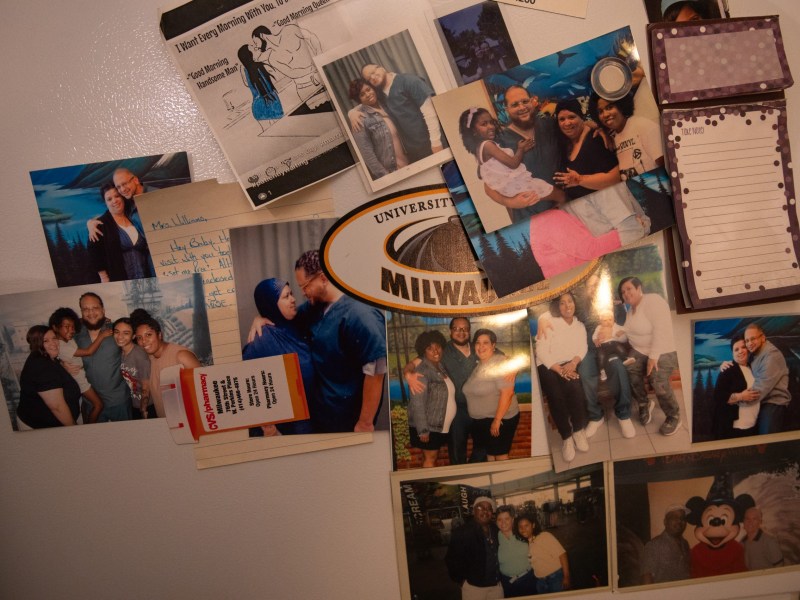 Photos of people, a note, a "University of Wisconsin-Milwaukee" magnet, a small notepad and other items