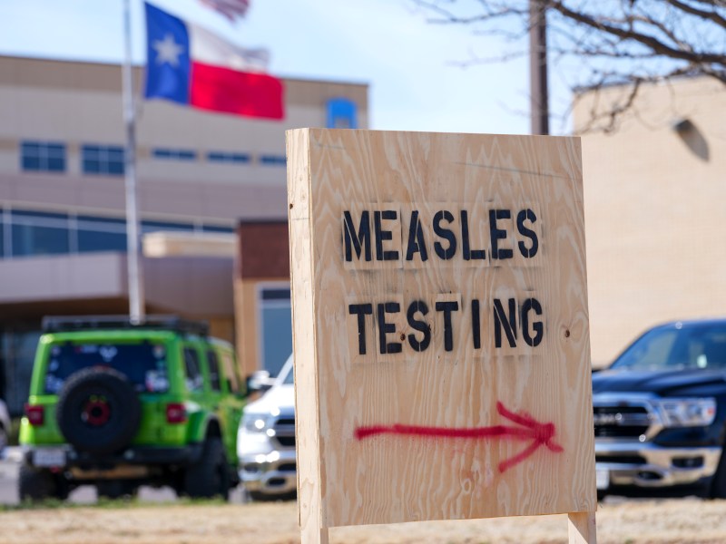 Measles testing sign outside building